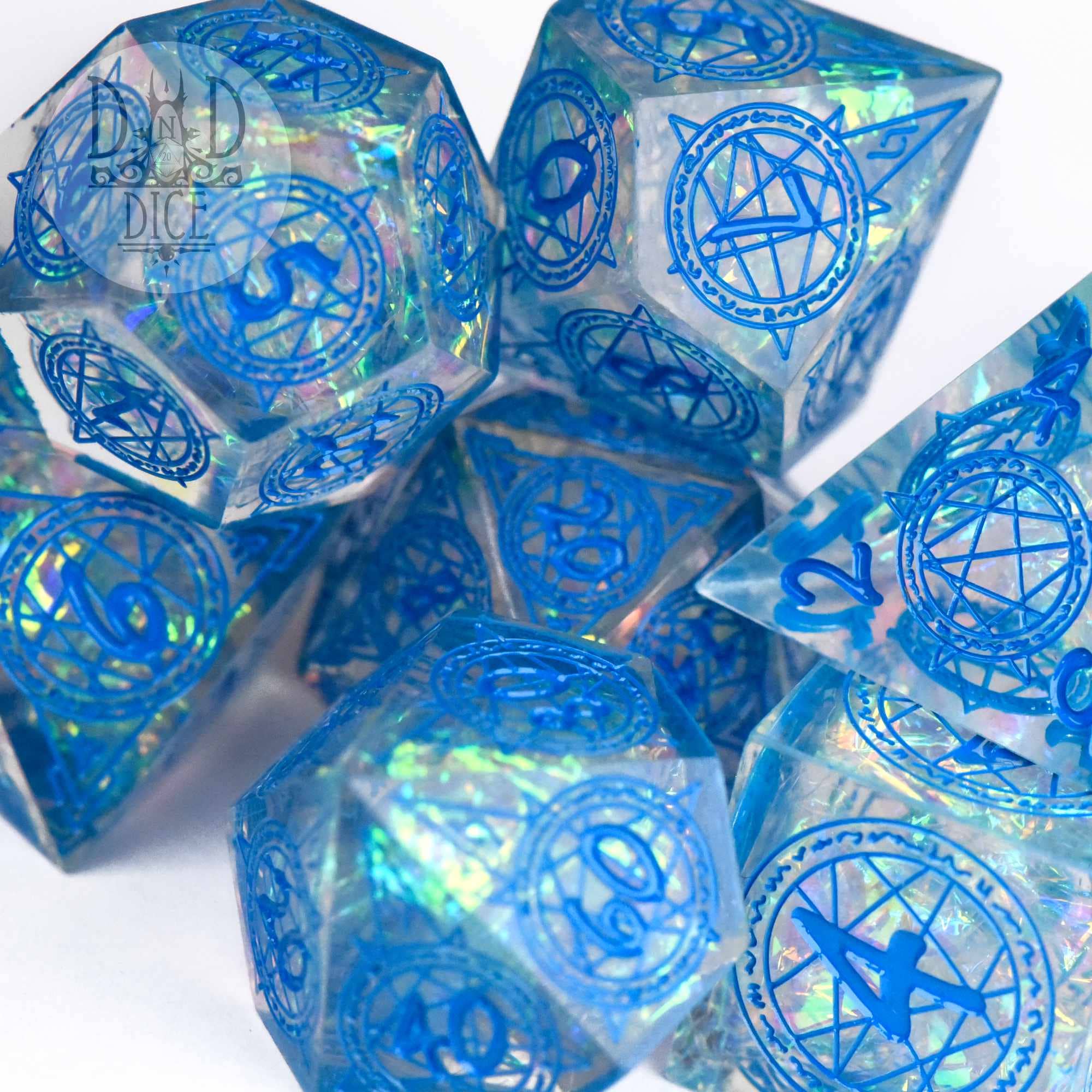 Crown of Magic (Handmade) 7-piece translucent blue resin dice set with iridescent flakes and arcane symbols.
