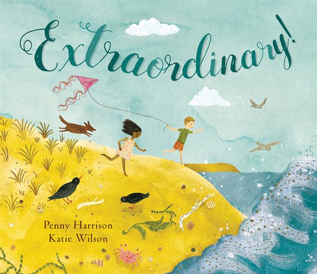 Two children run with a kite by the sea while holding Extraordinary.