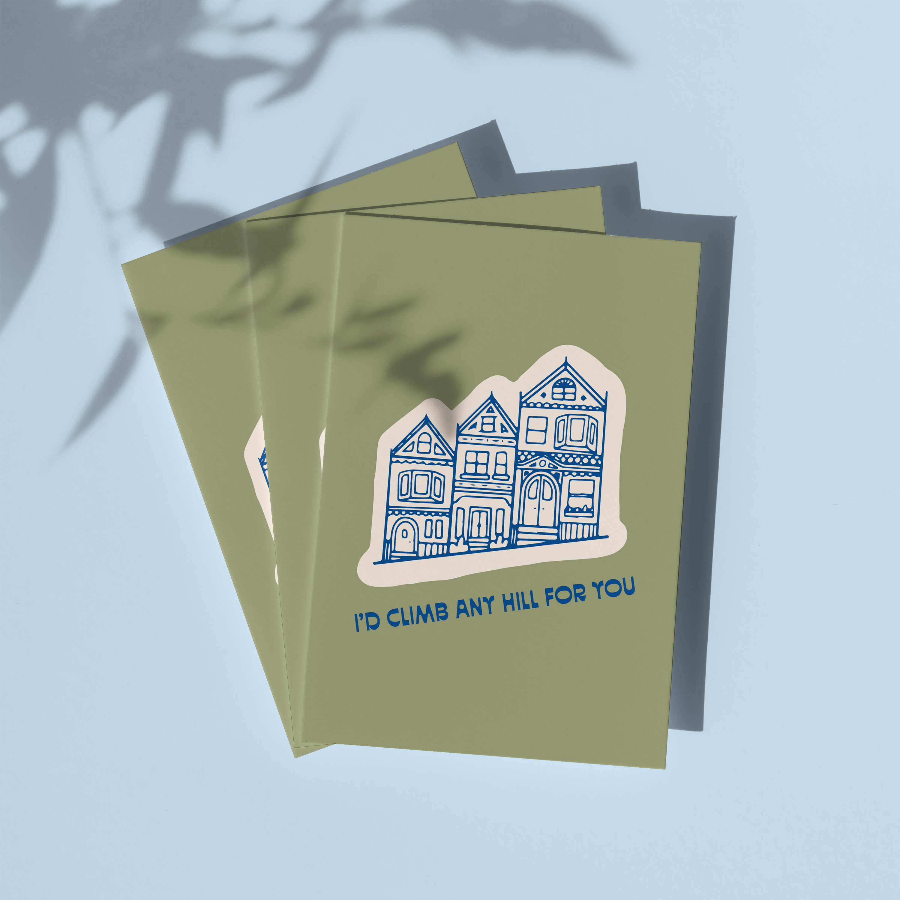 Three I’d Climb Any Hill For You cards by Aleisha Nelson displayed on a blue surface.