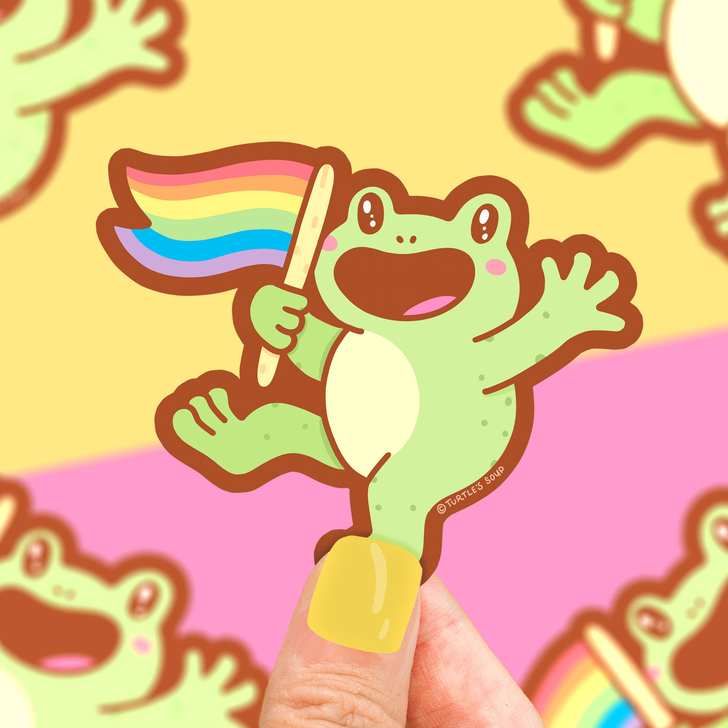 Pride LGBT+ Ally Flag Rainbow Frog waterproof vinyl sticker held by person with yellow nails.