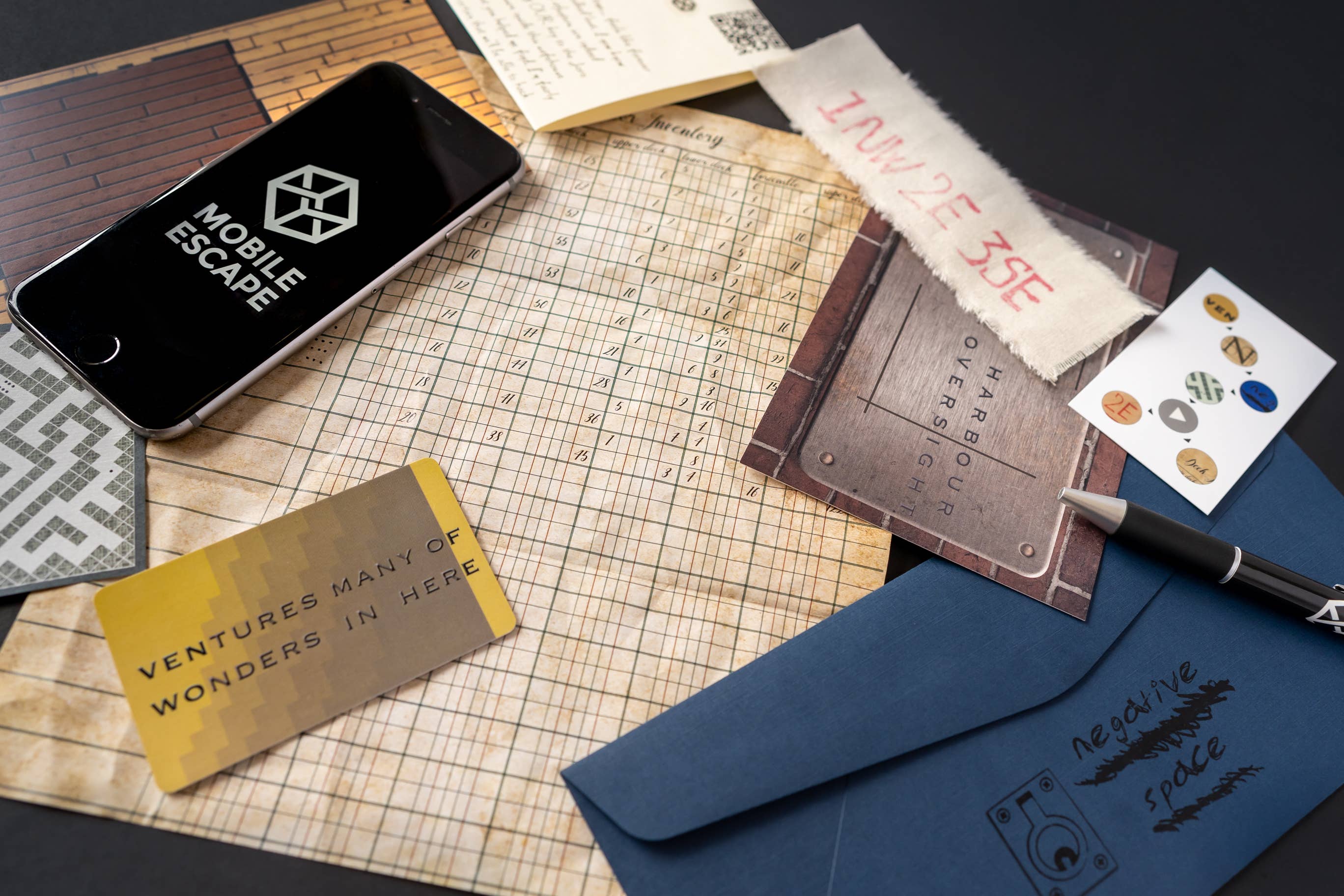 Family Secrets Ep. 9 - Best Served Cold clues, iPhone, notes, and blue Joro treasure envelope on tabletop.