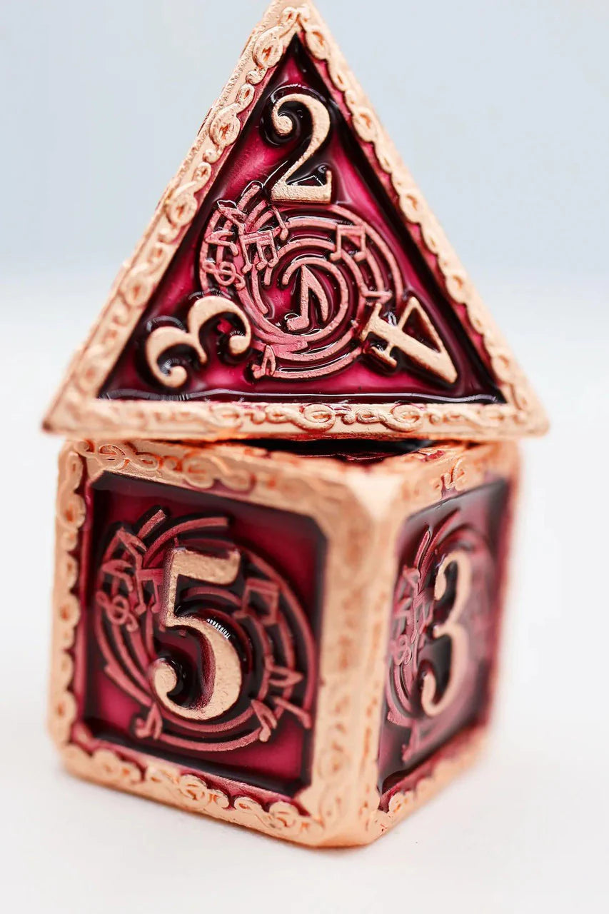 Bardic Song Allegro RPG metal dice set, red and gold with musical notes; triangle die displays the number 2.