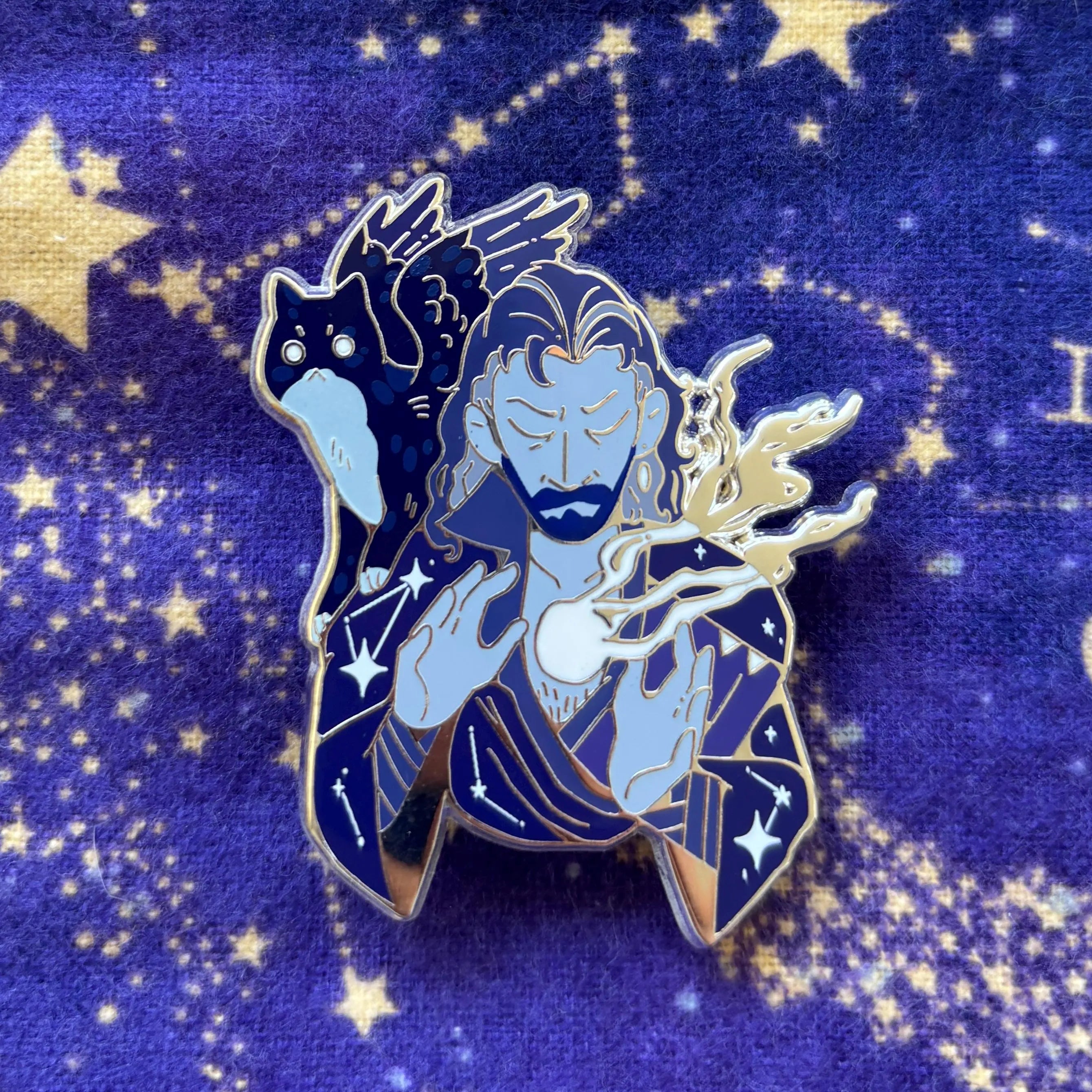 Gale Pins enamel pin featuring a magical wizard with glowing hands and a black cat on a starry purple background.