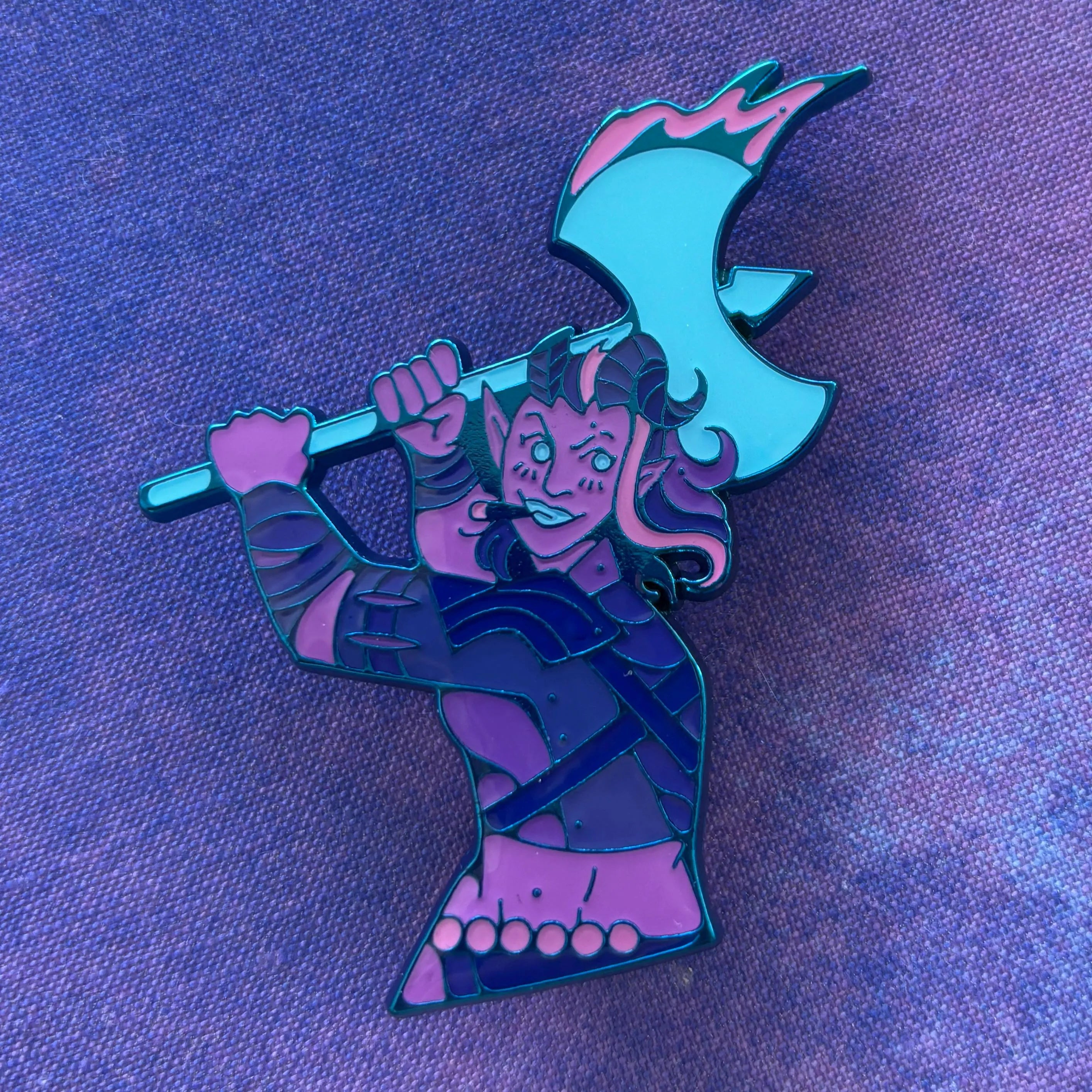 Karlach Dual Destinies enamel pin showing a horned warrior holding a blue axe on a purple background.