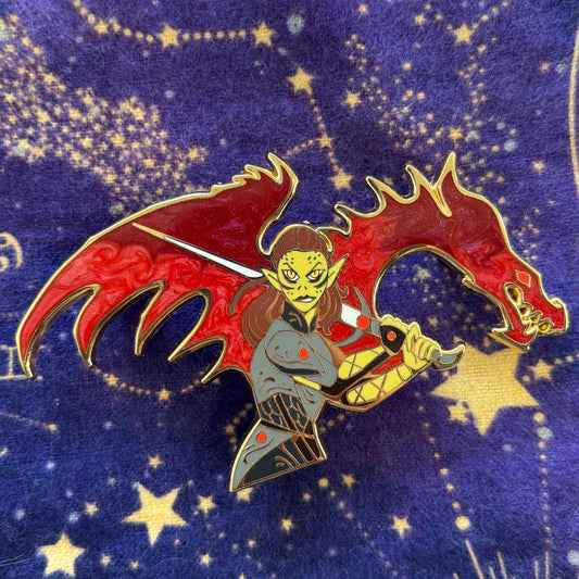 Laezel enamel pin featuring an elf warrior with red dragon wings and a sword on a blue background.
