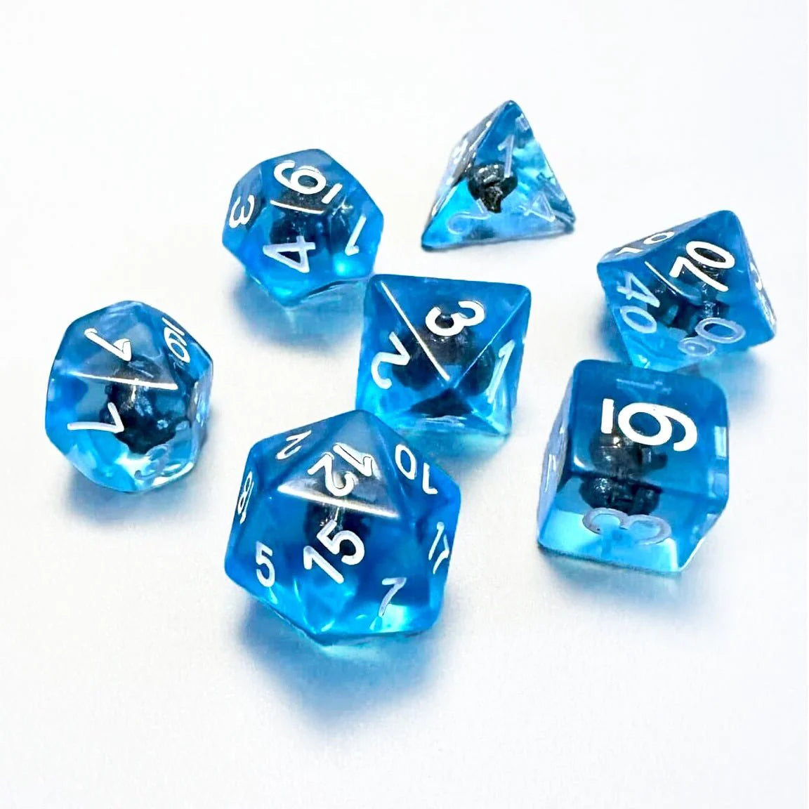Set of seven blue Land of Eem Gelatinous Goo dice with white numbers for tabletop roleplaying games.