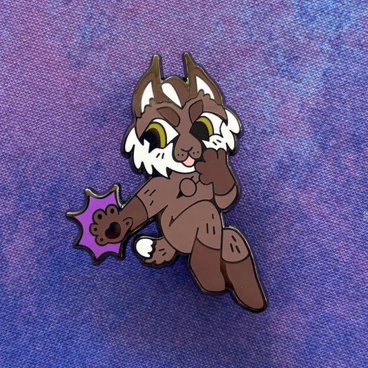 BG3 Cat Companion Pin showing a cartoon lynx holding up a purple paw.