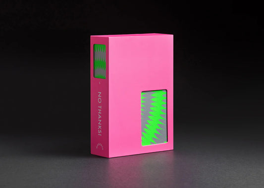No Thanks party game box, pink with green zigzag cutouts.