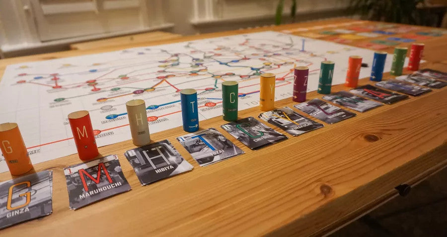 Tokyo Metro board game with colorful cylinders, cards, and a train line map themed after Tokyos rail system.