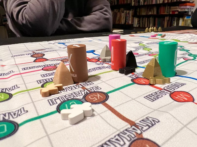Tokyo Metro Osaka Expansion game with pieces and action cards displayed on a mat.