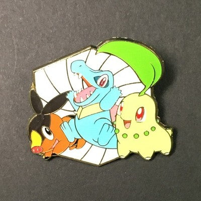 Totodile, Chikorita, and Tepig Pokemon enamel pin on a black background.