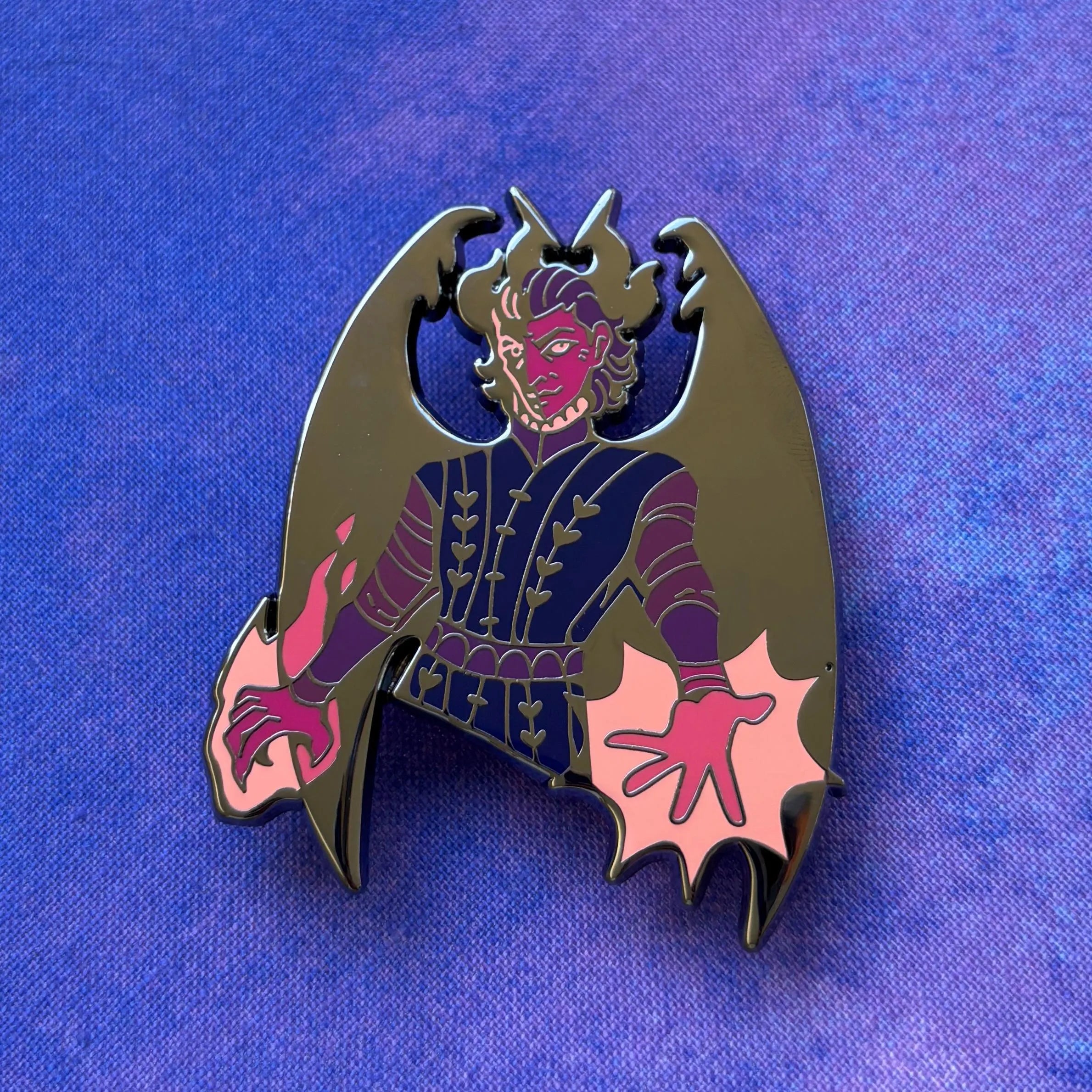 Raphael Pin depicting a purple-skinned, winged character with glowing hands on a blue and purple background.