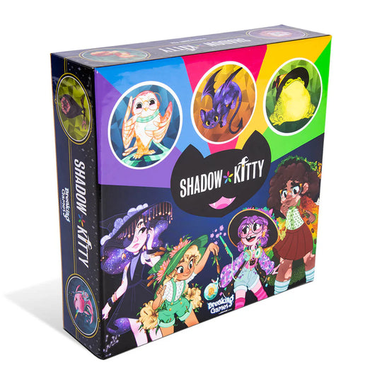 Shadow Kitty board game box with illustrations of magical girls, a cat, owl, frog, and dragon.