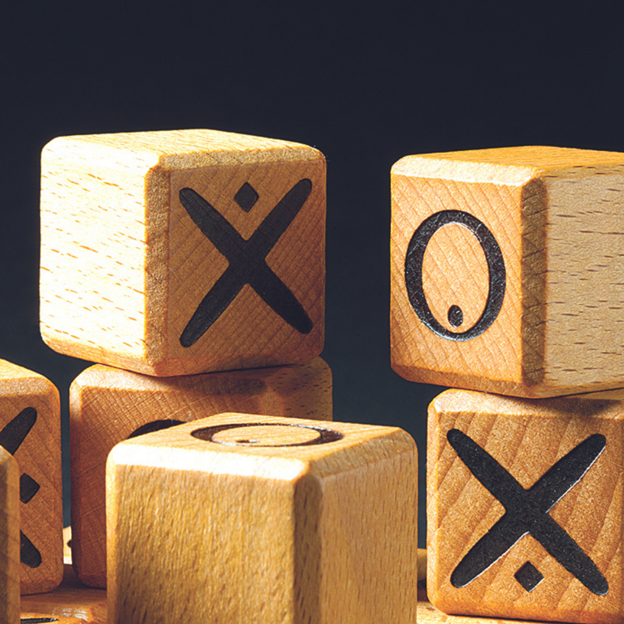 Quixo game blocks displaying X and O symbols stacked together.
