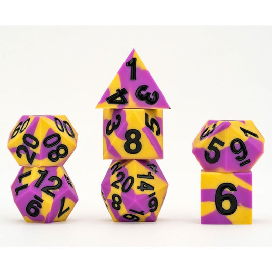 Three stacks of 7-piece silicone dice sets in Pride Intersex colors: purple and yellow with black numbers.