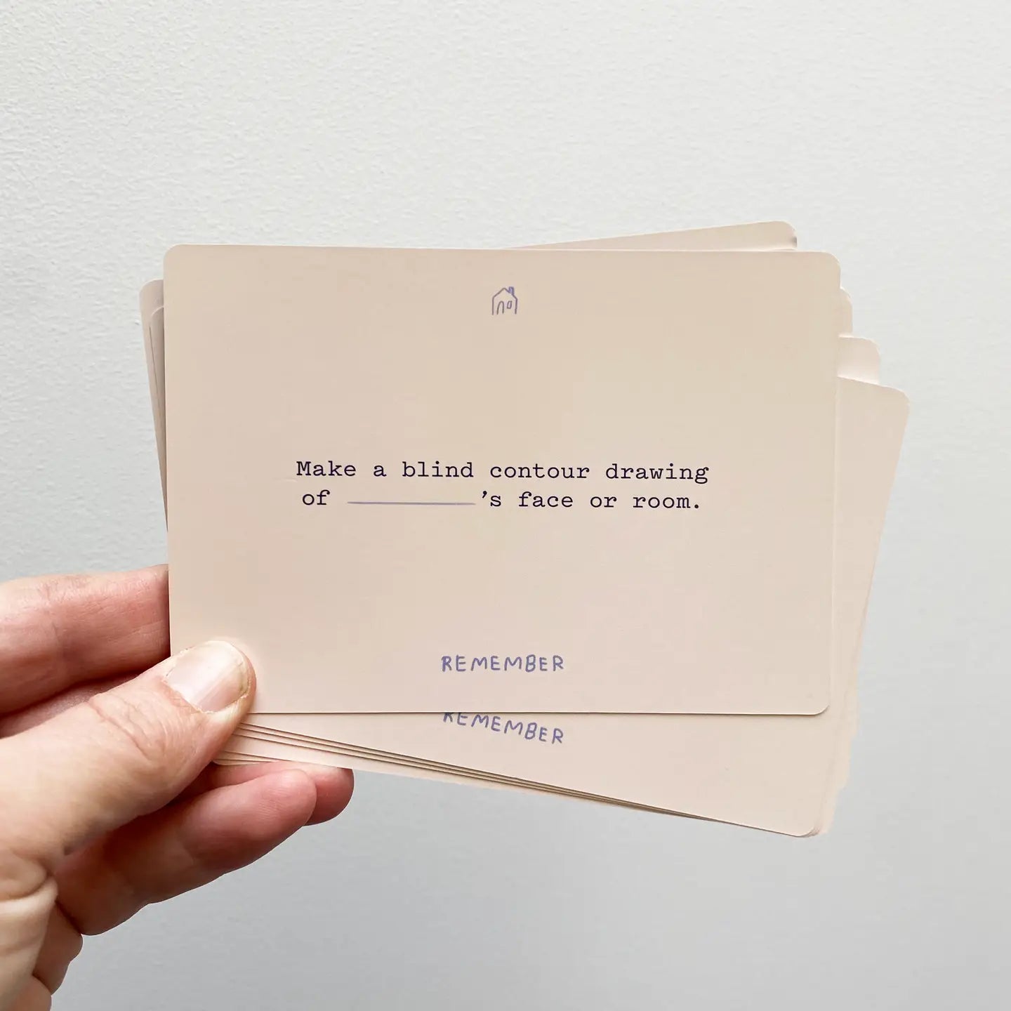 Sitting With Sadness Deck cards held in hand, top card reads: Try a coping prompt: draw ___’s face or room.