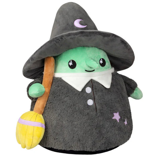 Green Squishable Witch plush with gray hat and cloak, holding a yellow broom, stars, and crescent moon.