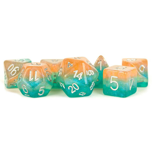 7-Set Layered Stardust Sunset Dice with orange and teal swirls, white numbers, shown on a white background.