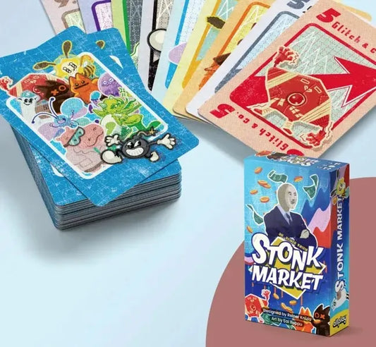 Stonk Market game box and stack of colorful playing cards on a light blue surface.