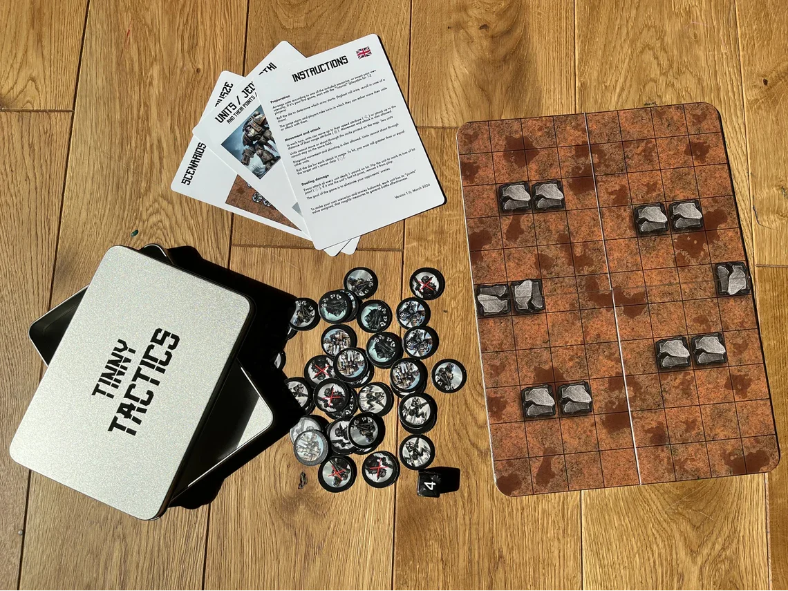 Tinny Tactics grid board wargame with armies, pieces, cards, and branded metal tin.