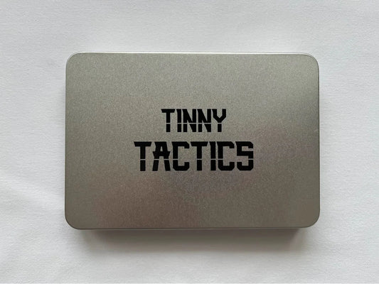 Silver tin labeled Tinny Tactics for storing tabletop wargame pieces.