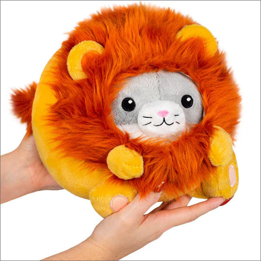 Squishable Undercover Kitty in Lion variant, a plush cat toy with an orange mane and cat face, held by hands.